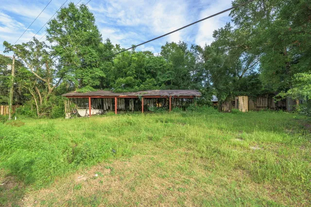 a backyard of a house with table and chairs