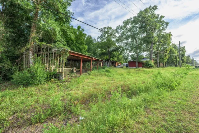 a backyard of a house with table and chairs