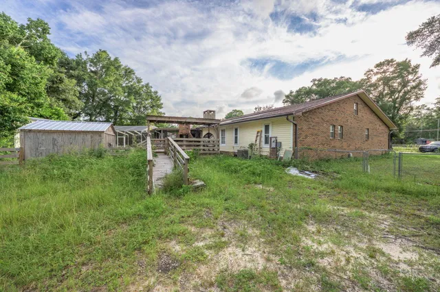 a view of a house with backyard and sitting area