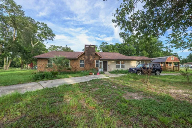 a front view of a house with yard porch and green space