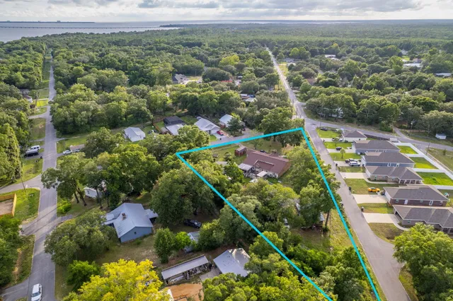 an aerial view of residential houses with outdoor space and swimming pool