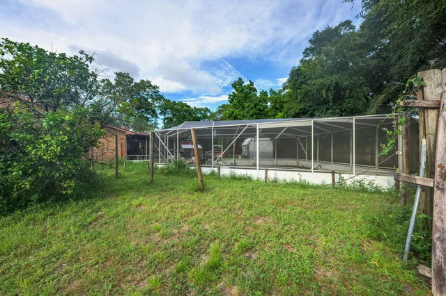 a view of a house with a backyard and a patio