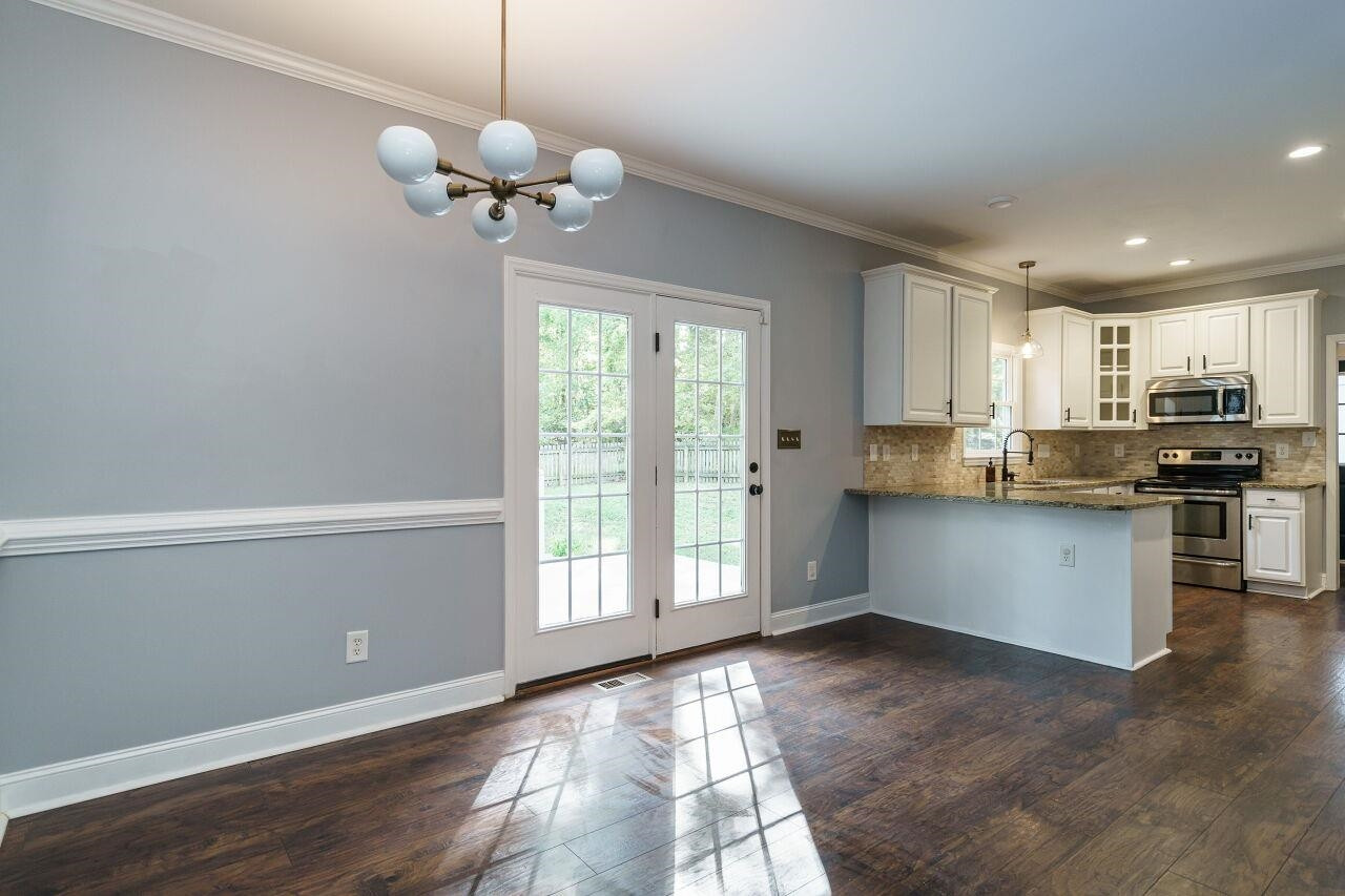 4202 Holt School Road Durham, NC 27704 - Photo 9 of 27 Imagine the simple pleasure of sipping your morning coffee as the sun's rays gently filter through, creating a warm and comforting atmosphere. Breakfast Nook