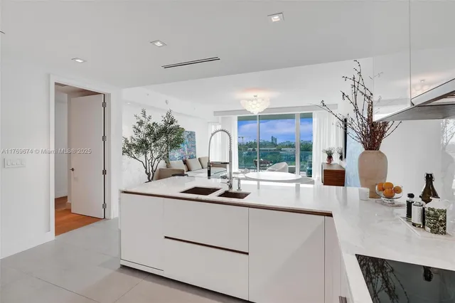 a kitchen with kitchen island a sink and a stove with wooden floor