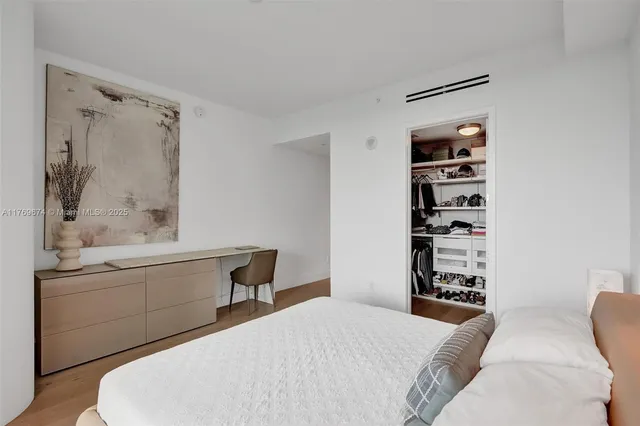 a bedroom with a bed and a walk in closet