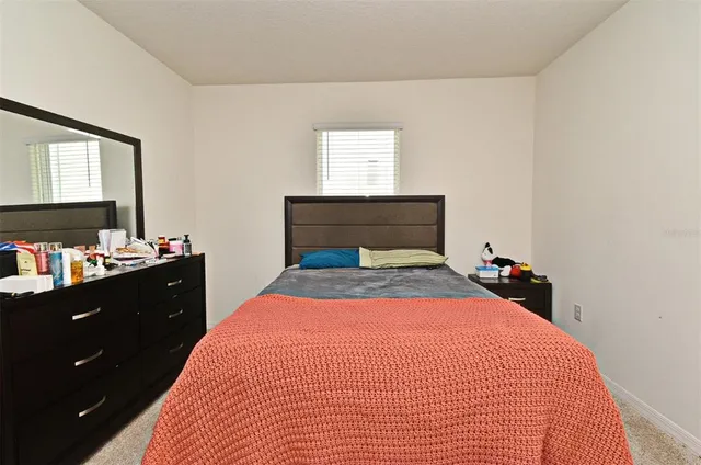 a bedroom with a bed and a dresser