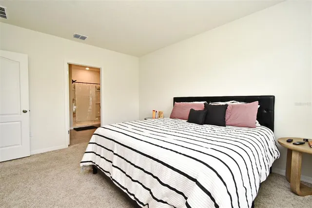 a bedroom with bed and a night stand