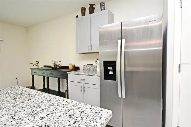 a kitchen with a refrigerator and a sink