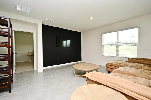 a spacious bedroom with two beds and a window