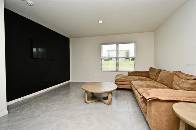 a living room with a couch and a flat screen tv