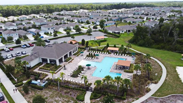 an aerial view of a house with garden space and lake view