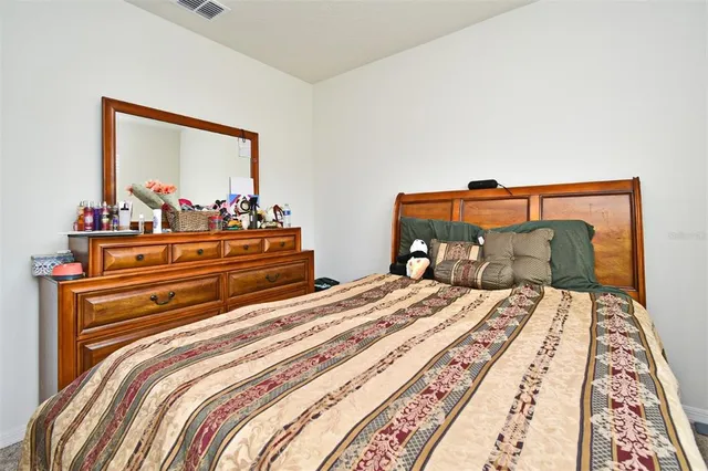 a bedroom with a bed and lamp