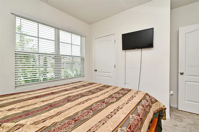 a bedroom with a bed and a flat screen tv