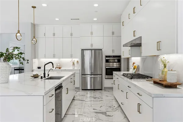 a closeup of a sink with white cabinets