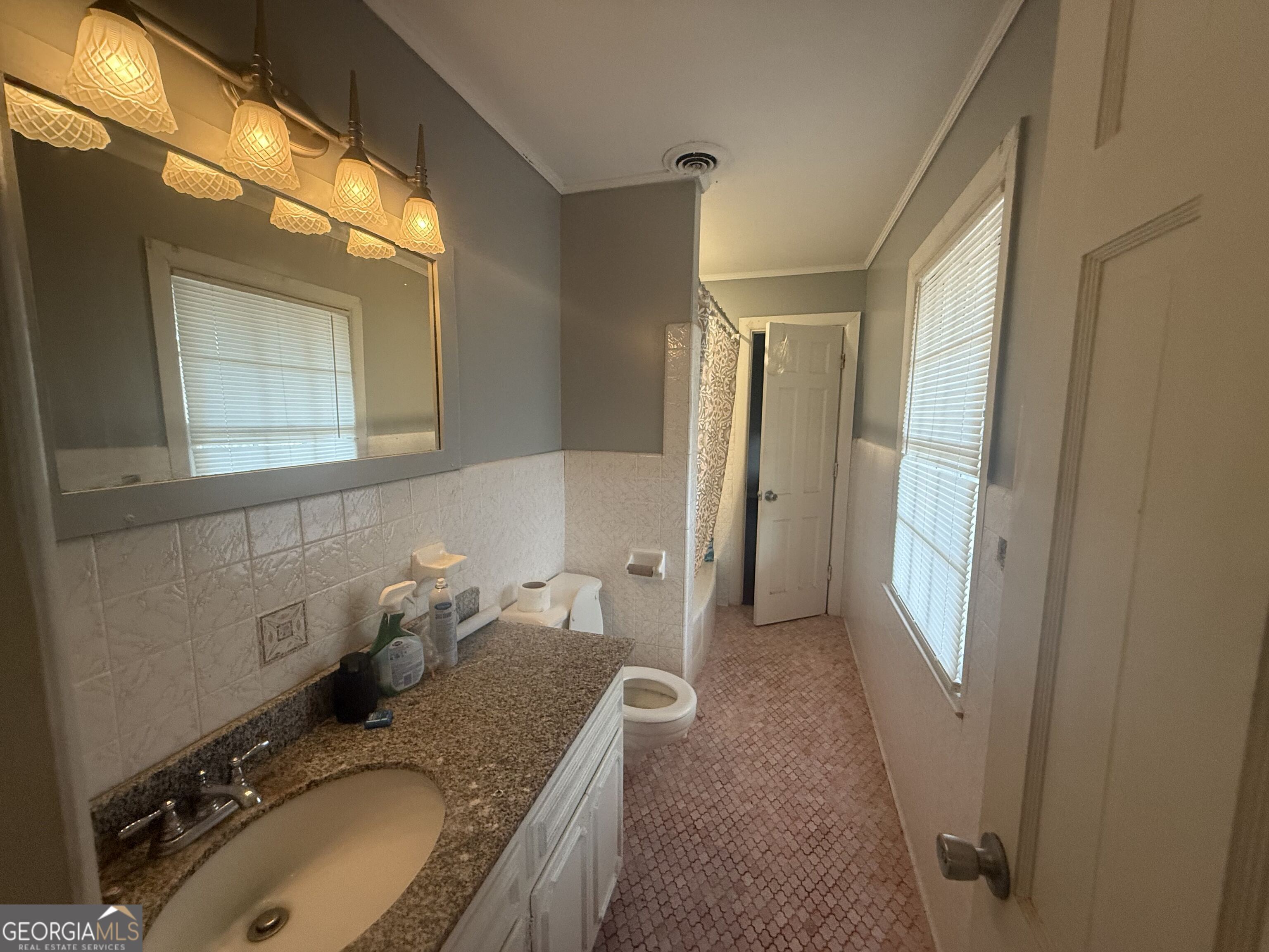 3861 Newnan Road Griffin, GA 30223 - Photo 53 of 89 a bathroom with a granite countertop sink and a mirror