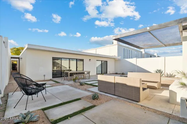 a living room with couches and kitchen view