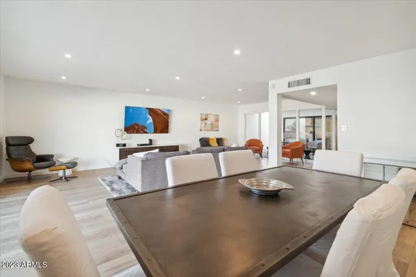 a living room with kitchen island furniture and a wooden floor