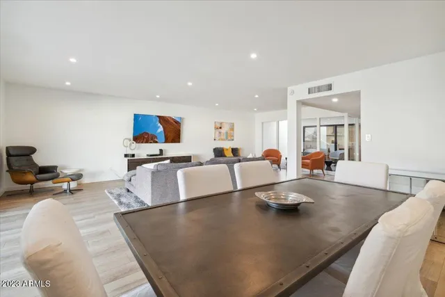 a living room with kitchen island furniture and a wooden floor