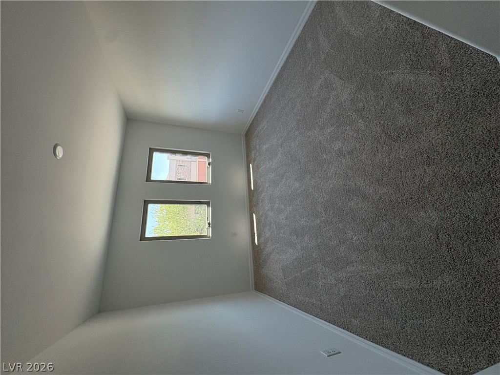 8677 South Indigo Springs Road Las Vegas, NV 89139 - Photo 5 of 9 Natural light streams into this pristine bedroom, ready for personalization.