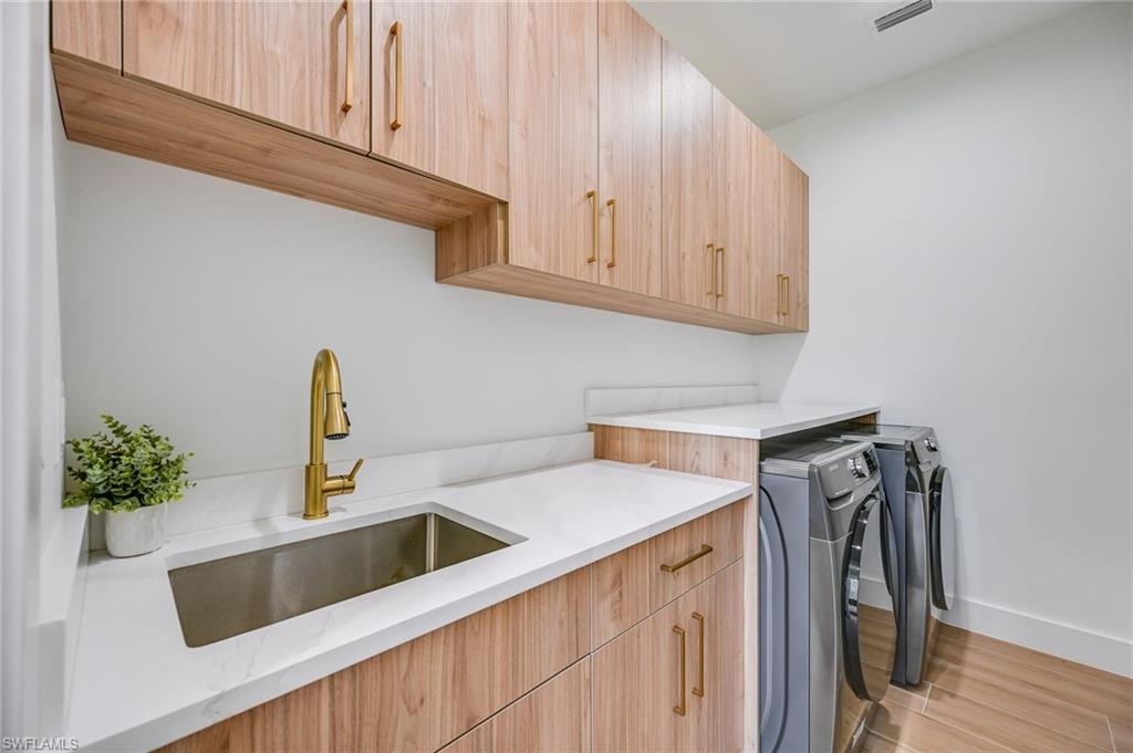 3384 Canal Street Naples, FL 34112 - Photo 11 of 34 a kitchen with a sink and cabinets
