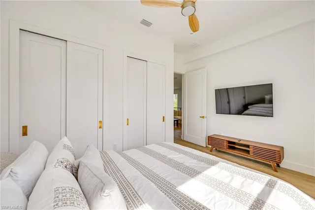 a bedroom with a bed and flat screen tv