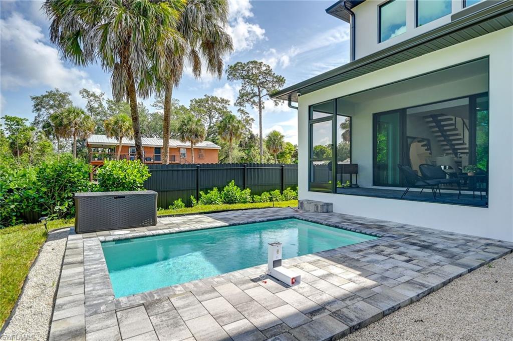 3384 Canal Street Naples, FL 34112 - Photo 30 of 34 a view of swimming pool with a garden