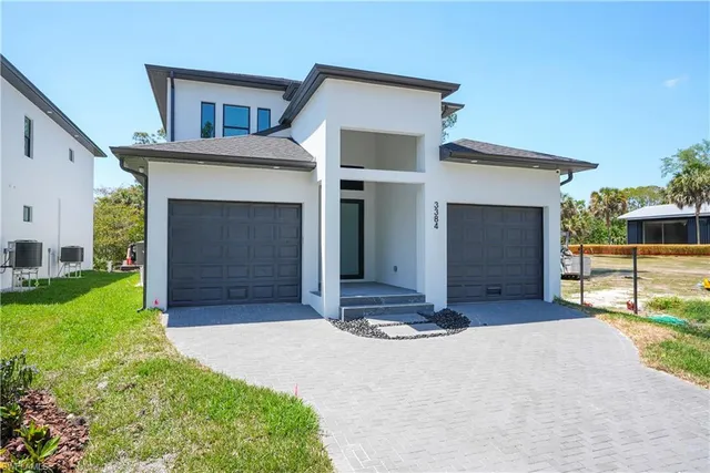 a front view of a house with a yard and garage