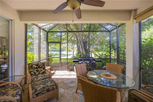 a dining room with furniture a rug and a large window