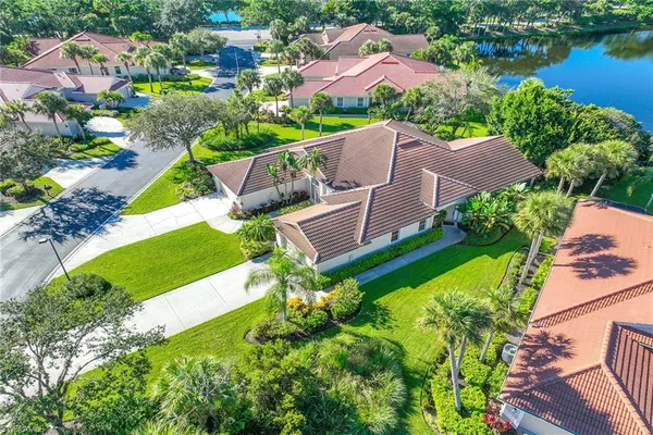 an aerial view of a house with a garden and swimming pool