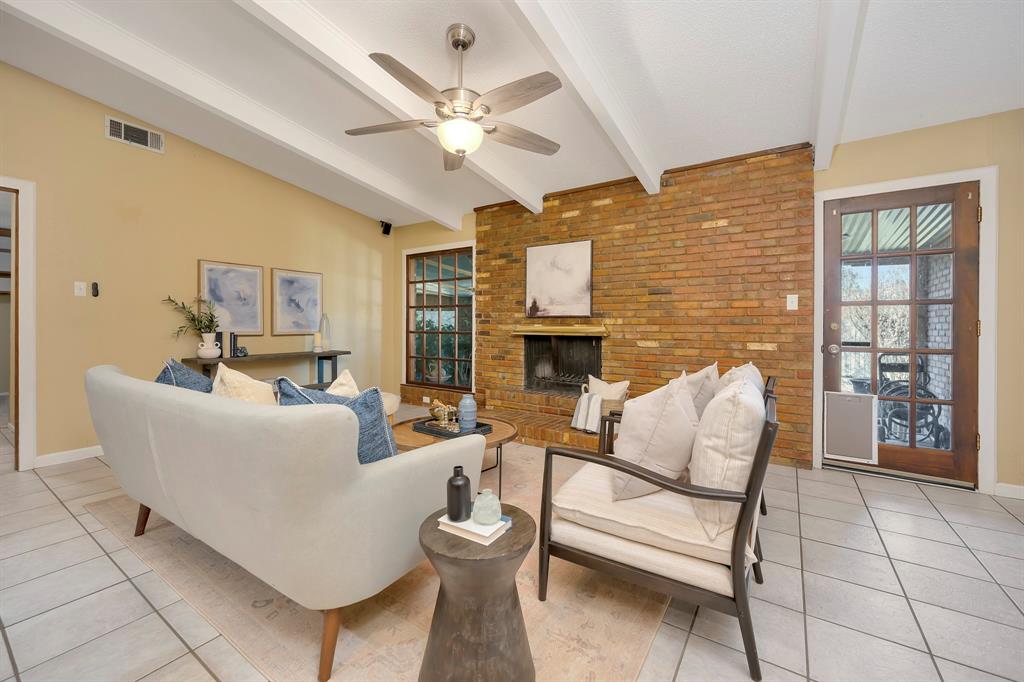 1761 Cynthia Lane Hurst, TX 76054 - Photo 15 of 40 a living room with furniture a fireplace and a flat screen tv
