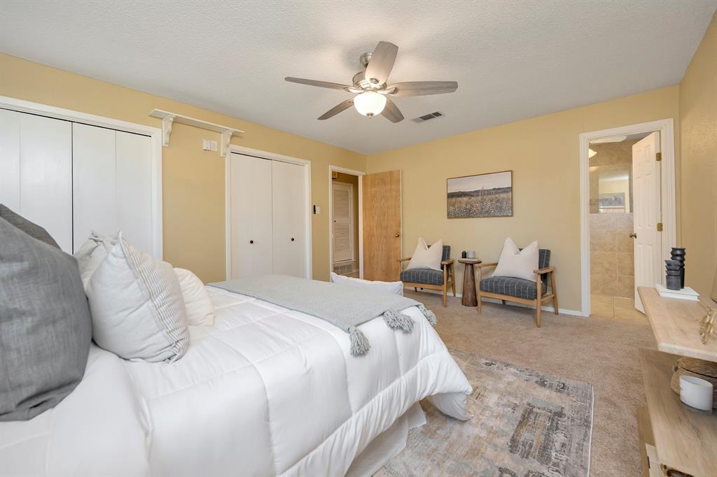 1761 Cynthia Lane Hurst, TX 76054 - Photo 26 of 40 a spacious bedroom with a bed and furniture