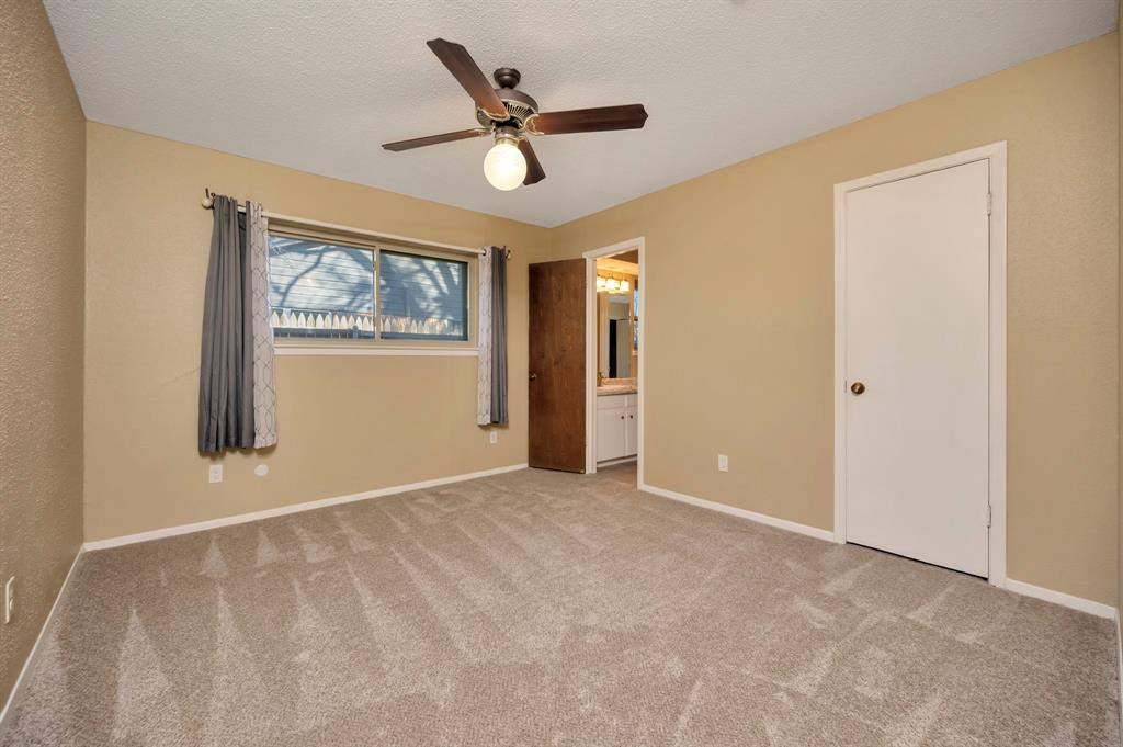 1761 Cynthia Lane Hurst, TX 76054 - Photo 31 of 40 an empty room with window and ceiling fan