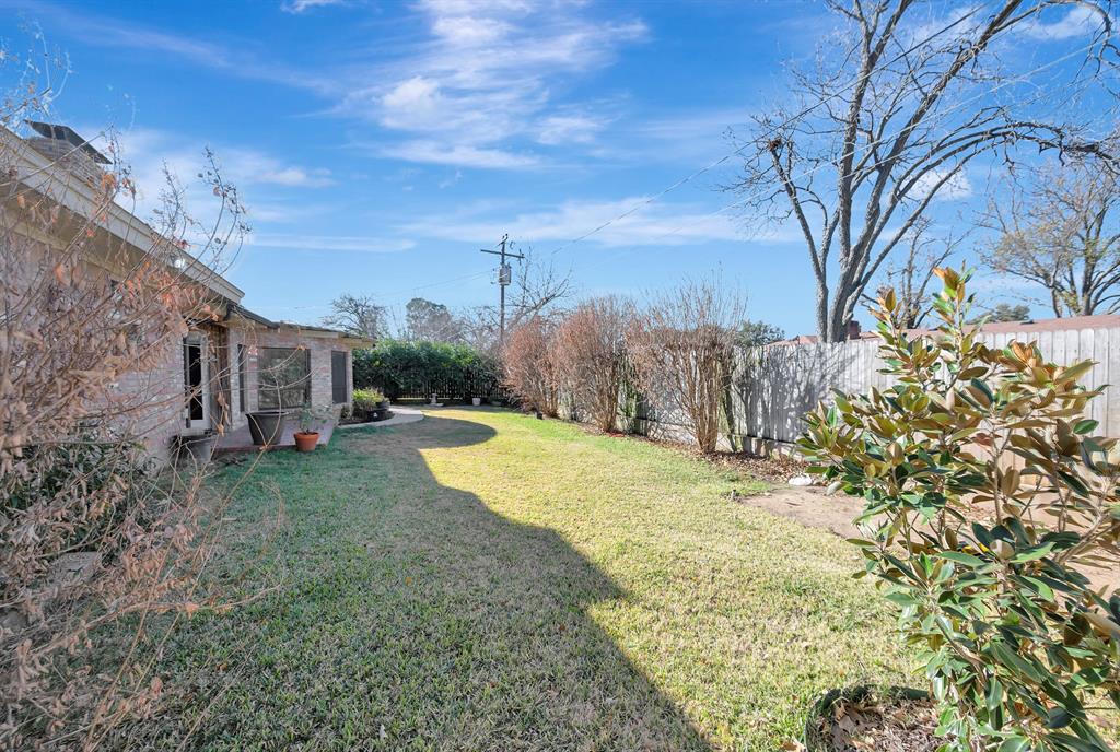 1761 Cynthia Lane Hurst, TX 76054 - Photo 38 of 40 a view of a backyard with large trees