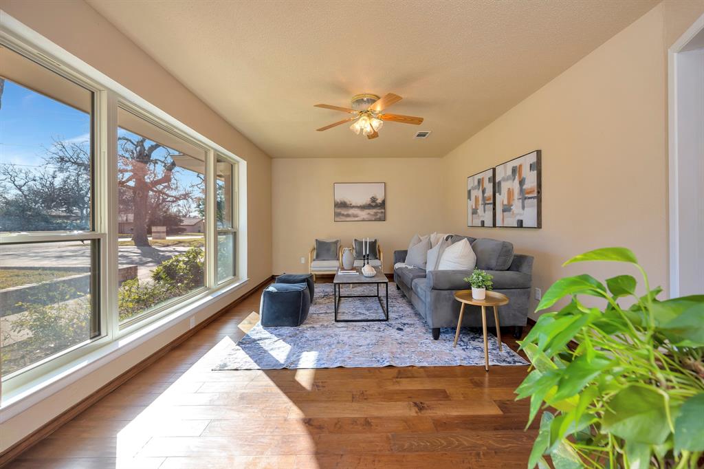 1761 Cynthia Lane Hurst, TX 76054 - Photo 8 of 40 a living room with furniture large window and a potted plant