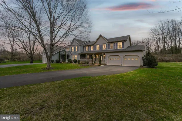 a view of a big house with a big yard and large trees