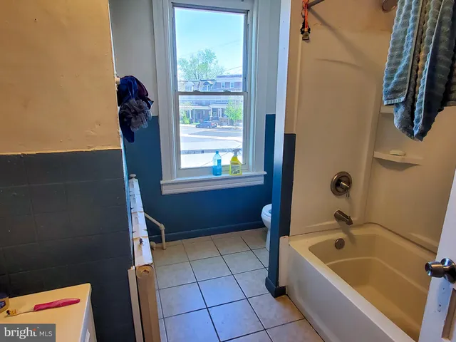 a bathroom with a tub a sink and a shower