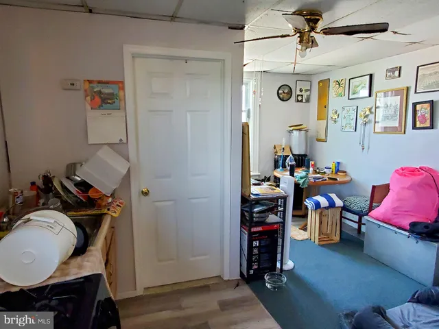 a view of a workspace with furniture and wooden floor