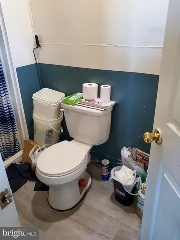 a white toilet sitting next to a bathroom sink and vanity