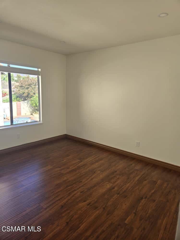 6492 Melray Street Moorpark, CA 93021 - Photo 35 of 59 an empty room with wooden floor and windows