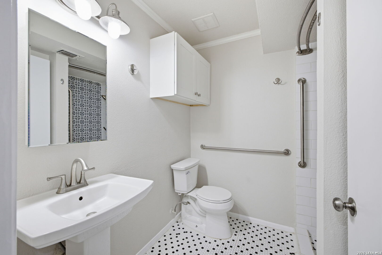6106 Vance Jackson Road, Unit 15 San Antonio, TX 78230 - Photo 15 of 30 a bathroom with a toilet sink and mirror