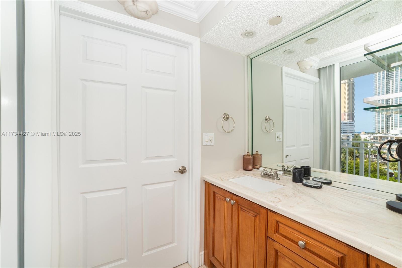 18000 North Bay Road, Unit 602 Sunny Isles Beach, FL 33160 - Photo 12 of 40 a bathroom with a sink and a mirror