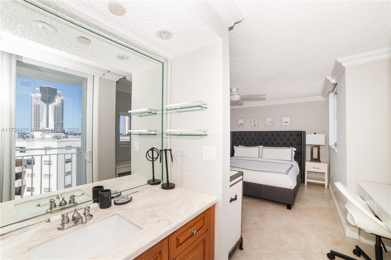 18000 North Bay Road, Unit 602 Sunny Isles Beach, FL 33160 - Photo 13 of 40 a kitchen with a refrigerator and a sink