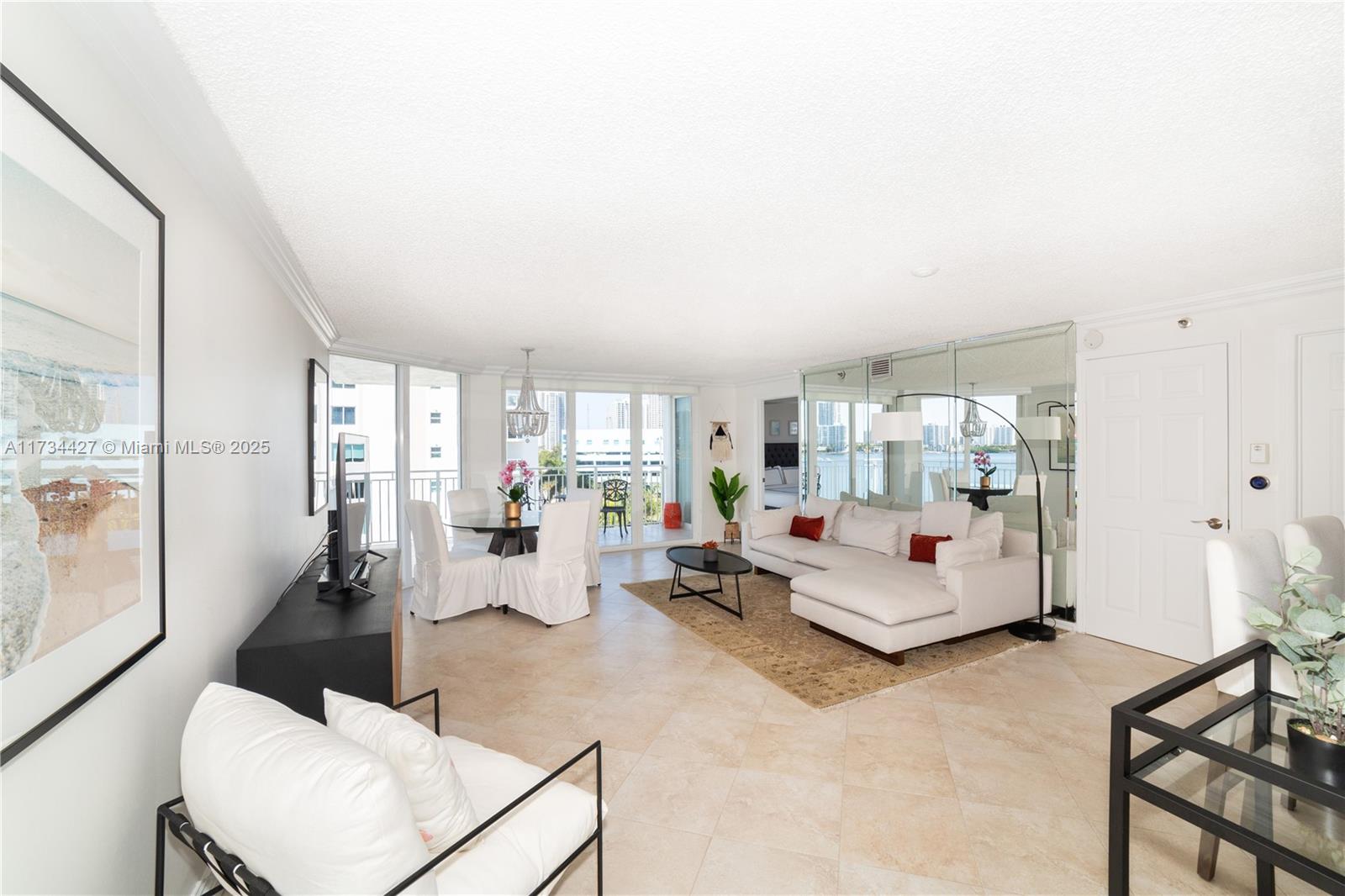 18000 North Bay Road, Unit 602 Sunny Isles Beach, FL 33160 - Photo 2 of 40 a living room with furniture and a large window