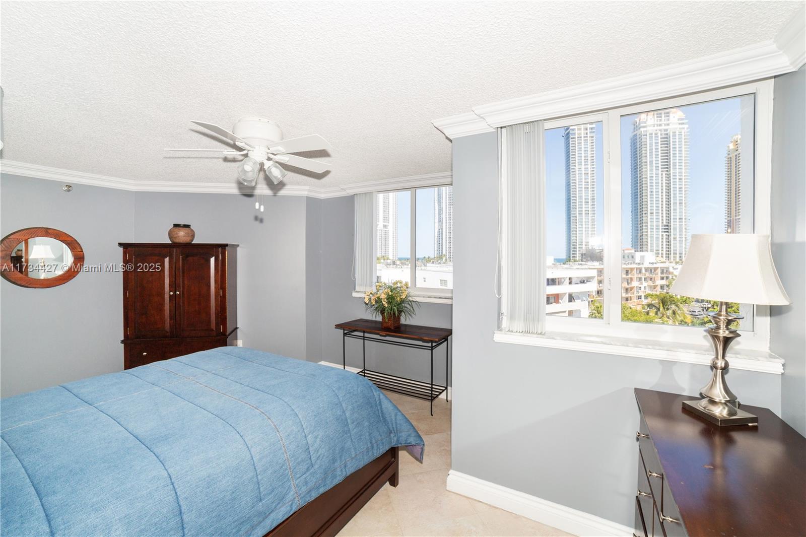 18000 North Bay Road, Unit 602 Sunny Isles Beach, FL 33160 - Photo 23 of 40 a bedroom with a bed mirror and a window