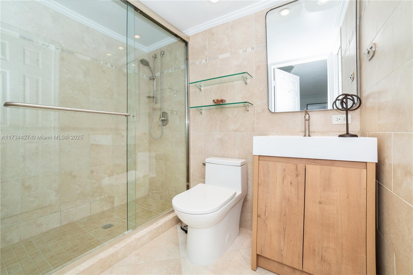 18000 North Bay Road, Unit 602 Sunny Isles Beach, FL 33160 - Photo 24 of 40 a bathroom with a sink a toilet and shower