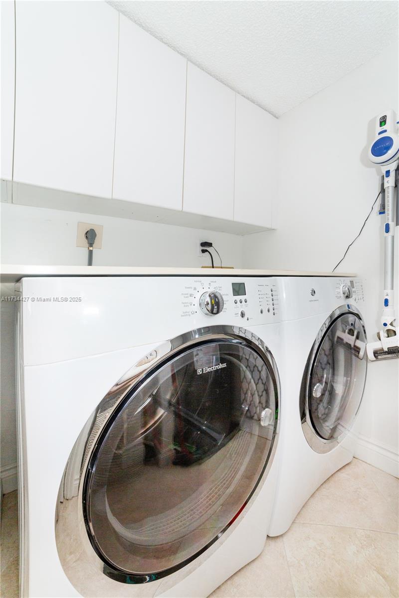 18000 North Bay Road, Unit 602 Sunny Isles Beach, FL 33160 - Photo 25 of 40 a utility room with dryer and washer