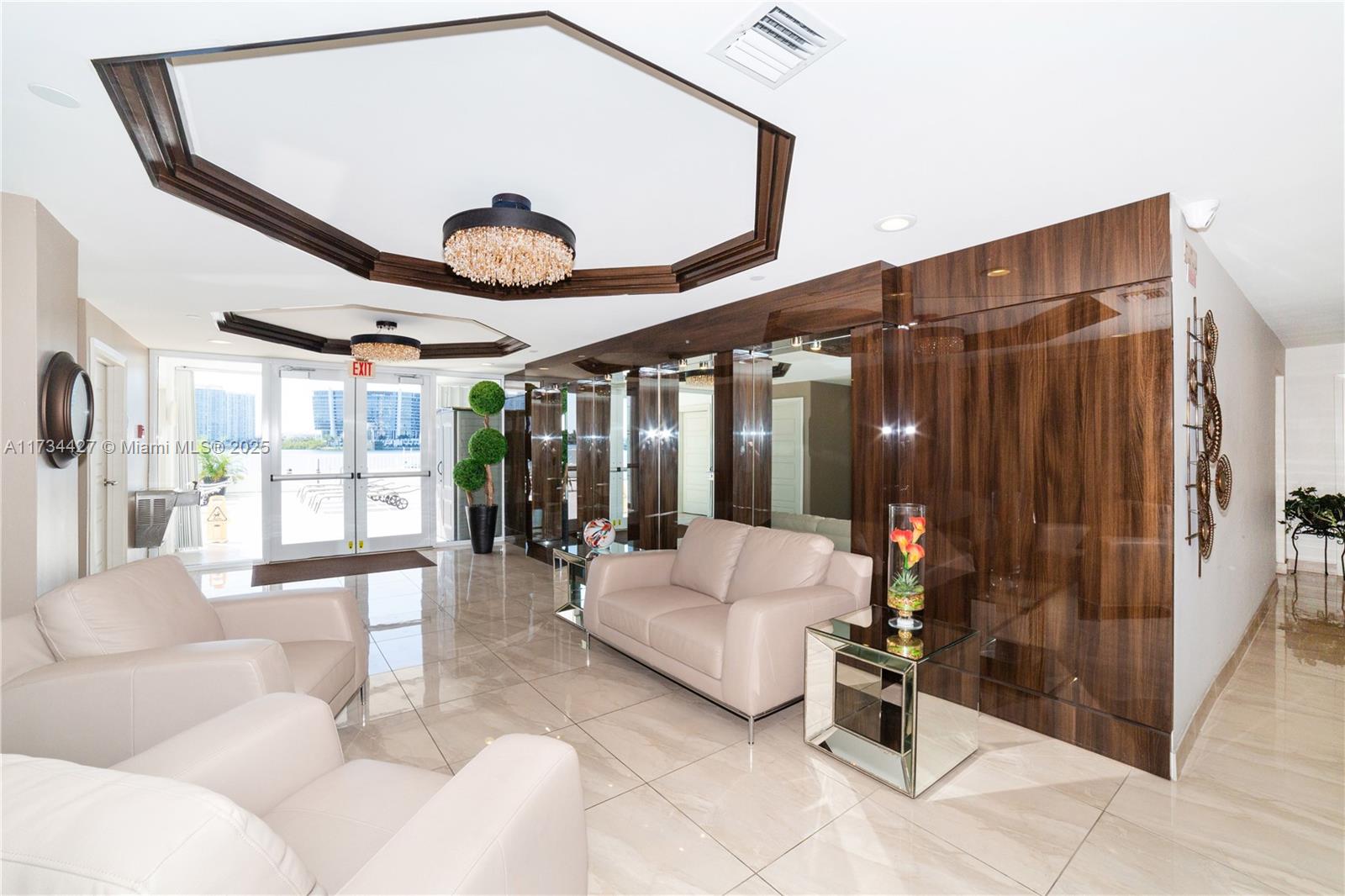 18000 North Bay Road, Unit 602 Sunny Isles Beach, FL 33160 - Photo 29 of 40 a living room with furniture and large windows