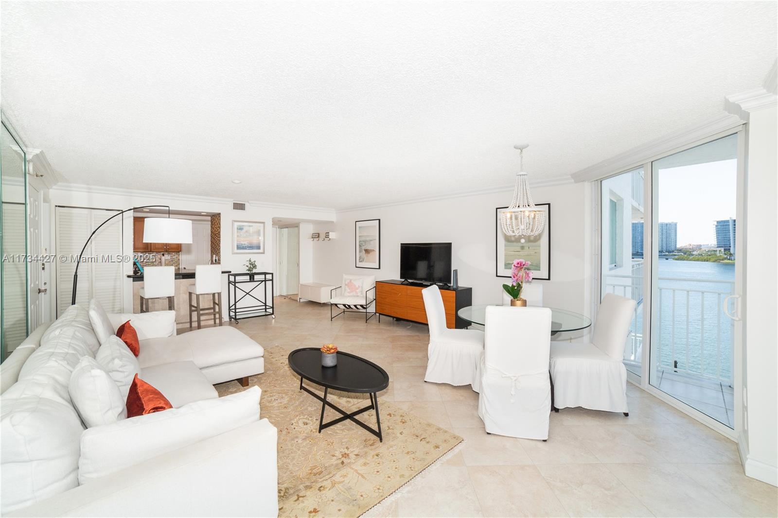 18000 North Bay Road, Unit 602 Sunny Isles Beach, FL 33160 - Photo 3 of 40 a living room with furniture and a table