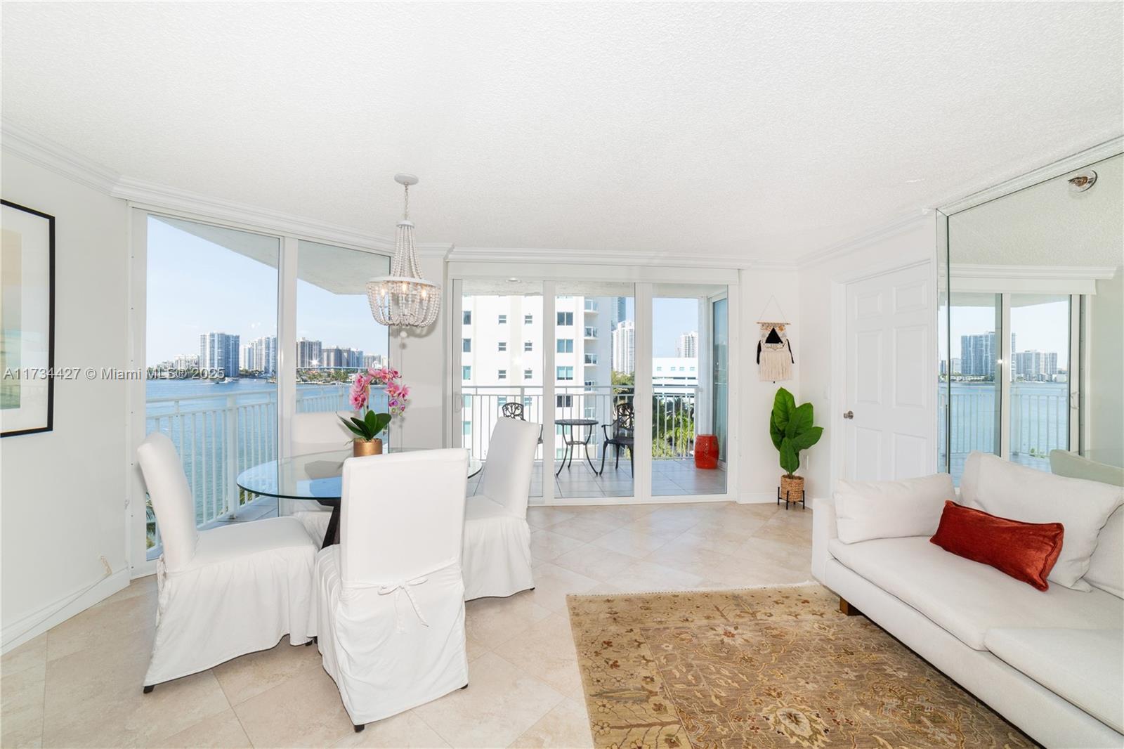 18000 North Bay Road, Unit 602 Sunny Isles Beach, FL 33160 - Photo 5 of 40 a living room with furniture and wooden floor