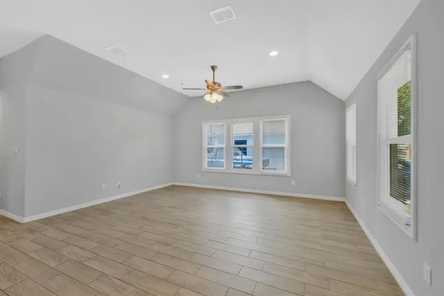 wooden floor in an empty room with a window